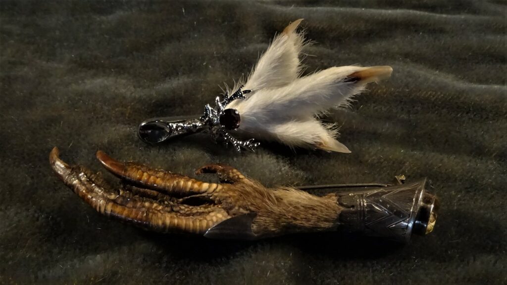 An older looking macabre klit pin and a newer white fluffy brooch from Miracle.